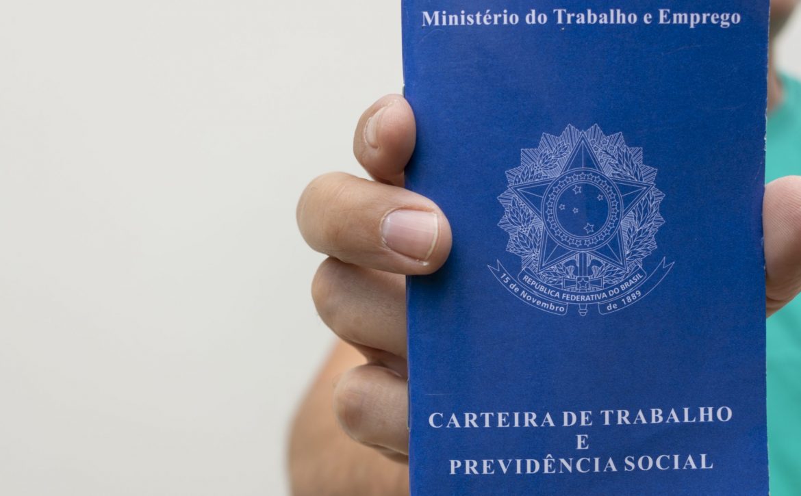 Man holding Brazilian job card, with space for text.