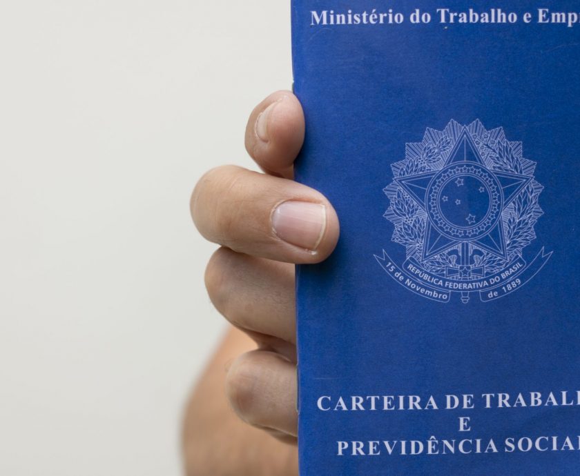 Man holding Brazilian job card, with space for text.